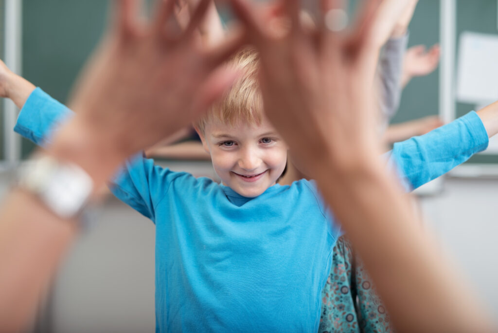 Young children rejoicing as they play at school